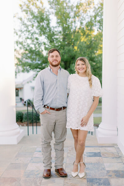 Couple smiling for the camera in a park