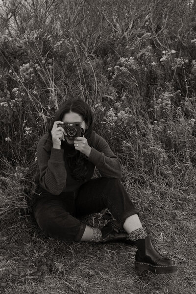 photographer sitting in grass