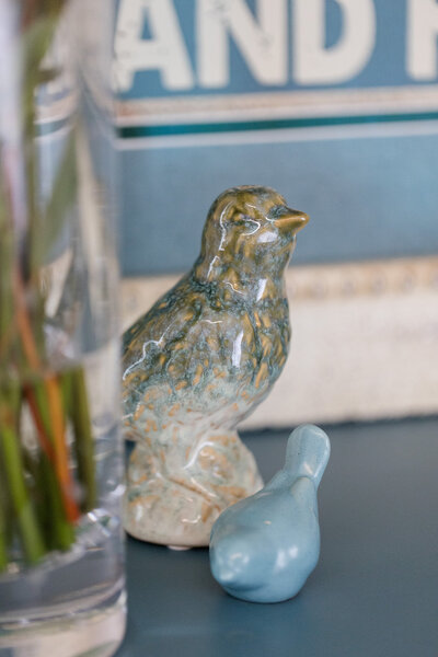 Ceramic bird decoration sitting on a table top