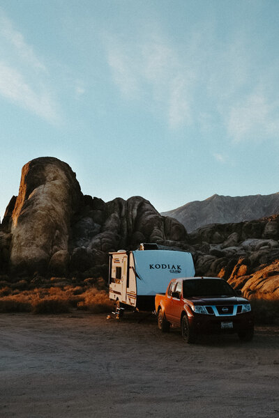 Red truck and travel trailer parked in Alabama Hills