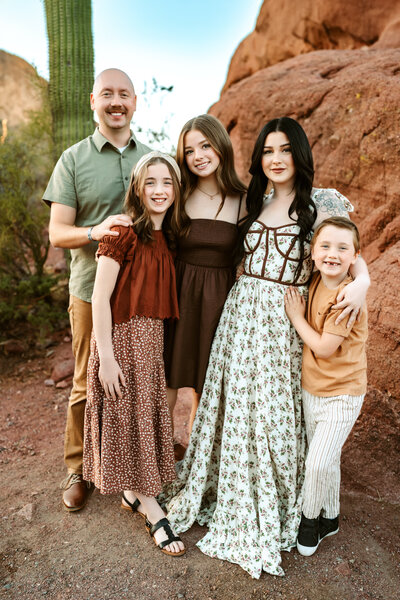 Family laying on blanket in grassy field in Flagstaff, Arizona