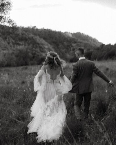 jac-dodge-new-mexico-wedding-couple-running-meadow