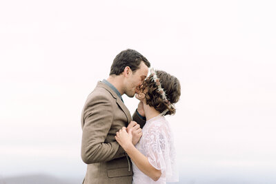 Close-up portrait of bride’s profile during quiet elopement moment, with wind and light creating movement.
