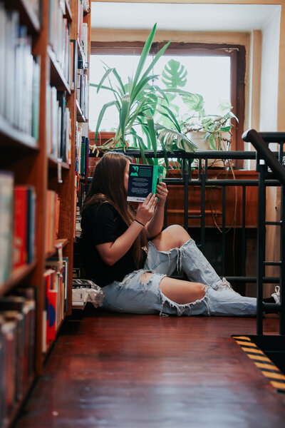 KP reads a book on the ground