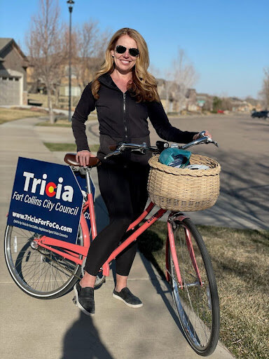 Image of Tricia on Bike delivering signs