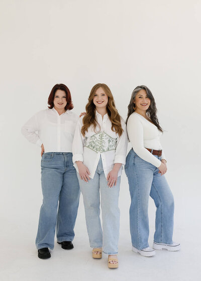 Holly, Nancy, and Sophia — the Klover Beauty bridal hair and makeup team — smiling together during a brand photoshoot for their Maryland-based business.
