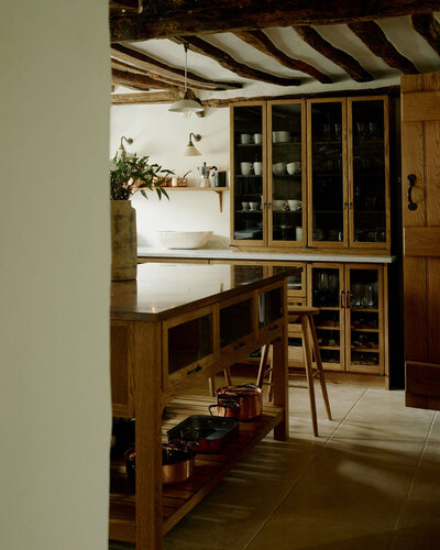 Bespoke kitchen at Rosemary House featuring handcrafted joinery, stone surfaces and a soft, natural palette, reflecting the grounded elegance of Cotswold design.