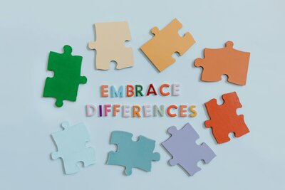 colored paper puzzle pieces surrounding wording saying "embrace differences"
