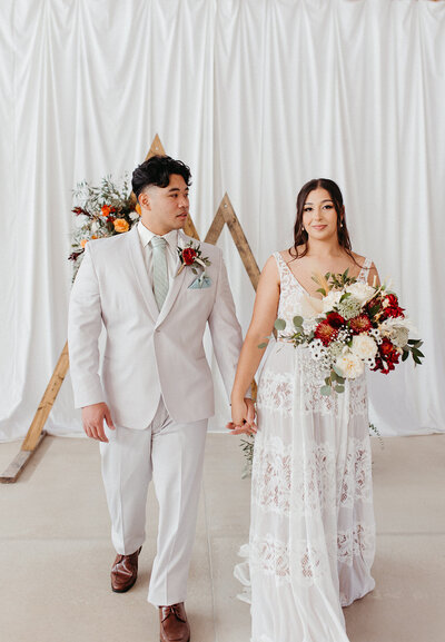 Bride and Groom at arbor alter just married at wedding venue in Olathe, KS