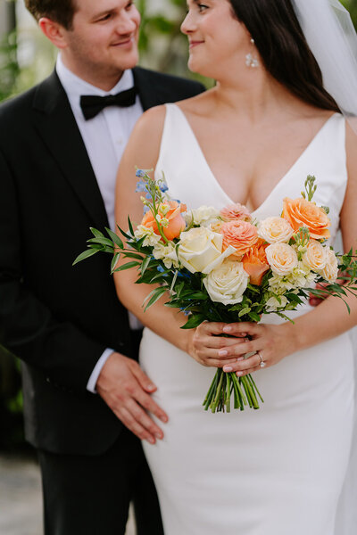 Bride and groom cuddling at sunset