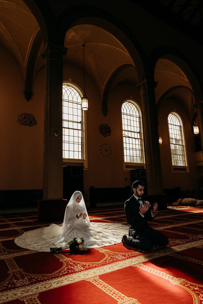 Muslim bride and groom pray in mosque before wedding