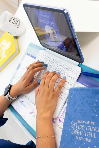 Online career coach working on her iPad in the office using professional tools, HR Mami Career Coaching