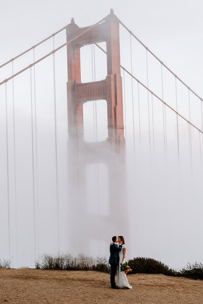 couple kissing in front of Golden Gate Bridge