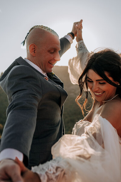 couple dancing in sedona wedding dress with sleeves pearl necklace