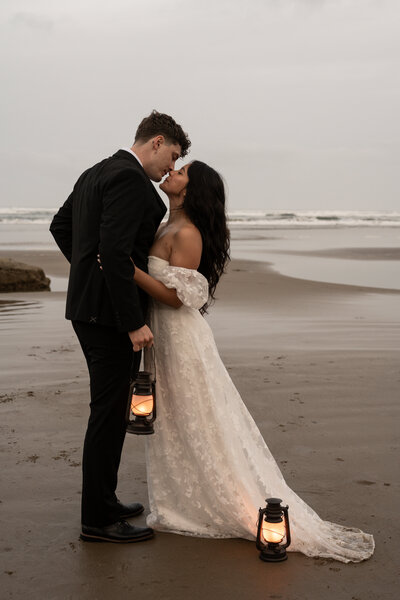 bride and groom kissing on a beach taken by idaho wedding photographer