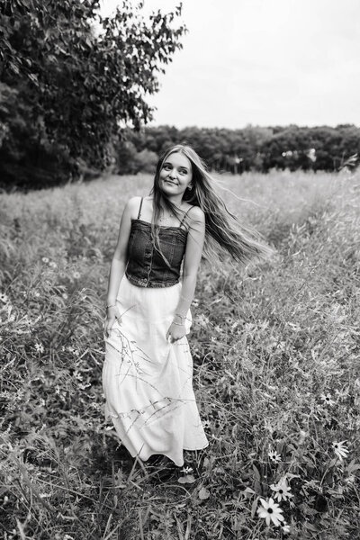 Senior photo of a soon to be graduate in a flower field