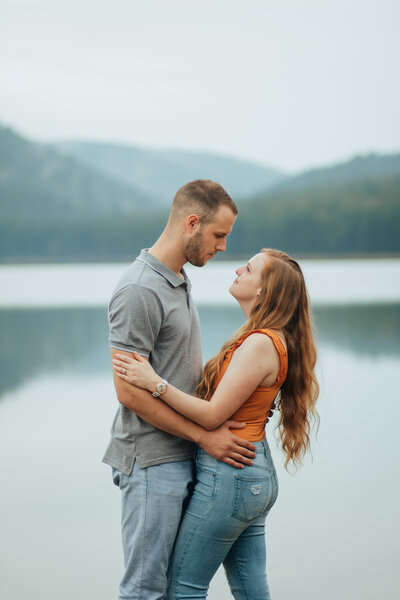 couple hugging by lake