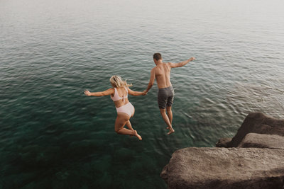 couple jumping into water
