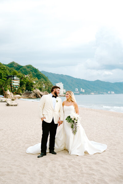This vibrant destination wedding in Puerto Vallarta, Mexico featured a beachfront ceremony, lush tropical florals, and a joyful celebration under the palms. Perfect inspiration for couples planning a colorful wedding by the sea.


