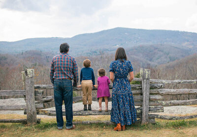Jess, heJess outside with her family enjoying the mountains