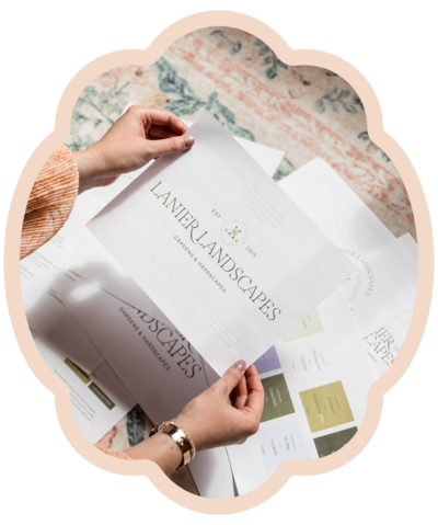 Holding stacks of paper showing brand identity proposal