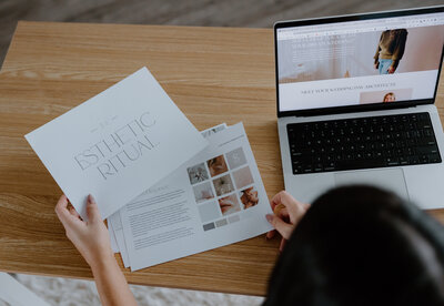 Danielle looking through brand moodboard papers on desk