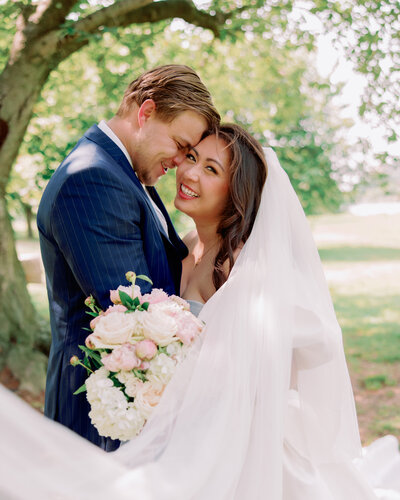 A couple stands forehead to forehead at a Collingswood Wedding.