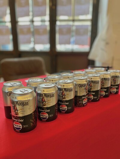 branded calligraphy on captain morgan cans