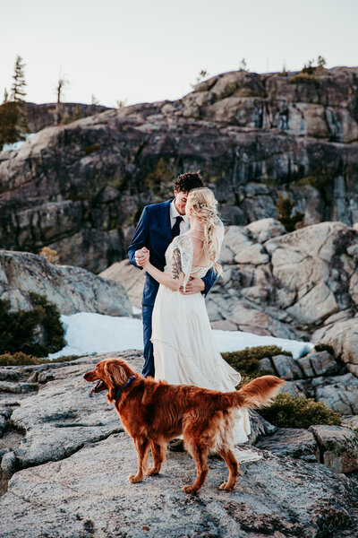 Bride and groom embracing on a dock at Lake Tahoe, with boats and mountains in the background, featured in a 'How to Plan Your Lake Tahoe Elopement' guide.