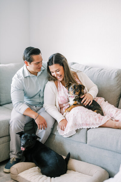 Makayla Rivera, her husband, and their two dogs on a couch