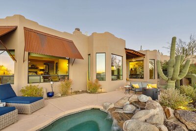 Luxury Cave Creek, Arizona home with private backyard, pool, desert landscaping, and sunset views.