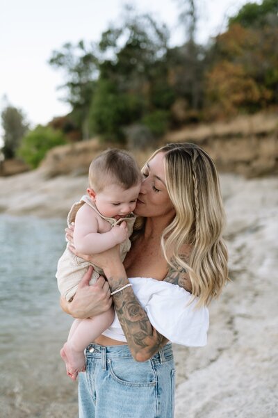 woman kissing baby on the cheek