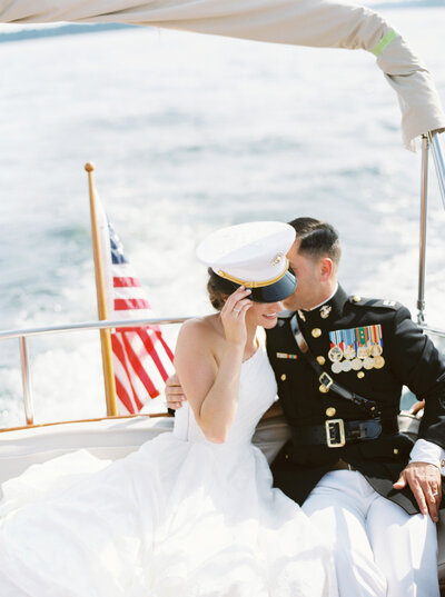Seattle Wedding Photographers - navy groom and bride on boat bride wearing white sailors hat