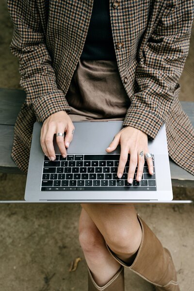 hands typing on laptop keyboard