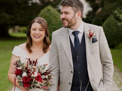 Bride-&-Groom-walking-&-laughing-together-after-their-potrait-session-in-The-Moyvalley-Hotel-Gardens