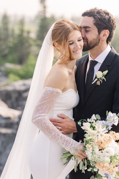Smiling woman stands with blush balloon backdrop during Wildflower Events brand session | Zoe Evans Brand Photography