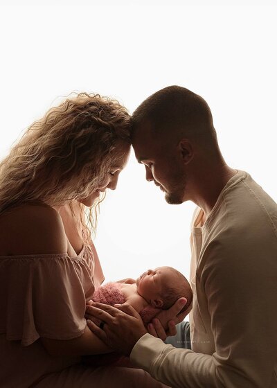 photo shoot with family of 3 newborn baby