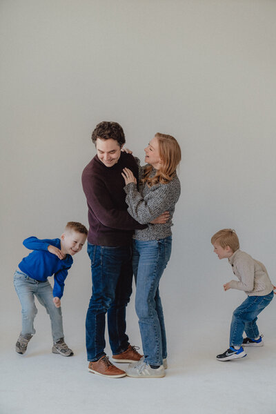 a family plays in photography studio