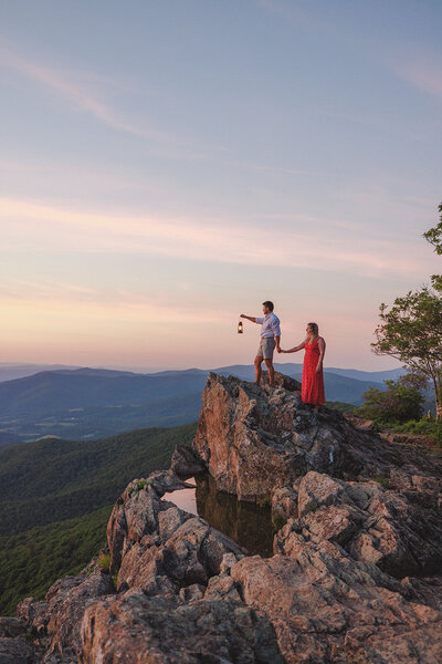 couple stands on the rocks of the blue ridge mountains together