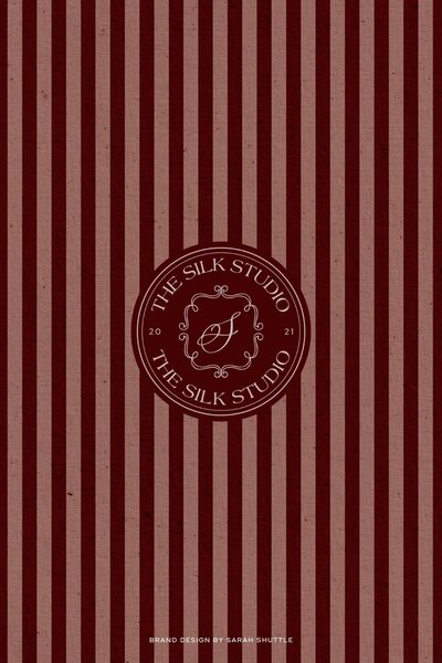 Bespoke brand identity for a silk company, featuring an ornate emblem and striped elements.