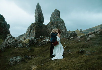 Soaked and laughing couple eloping in the rain in Scotland — joyful, candid elopement photographer vibes