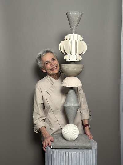 Artful Sweets cake artist with tall, abstract, multi-tier, art deco cake