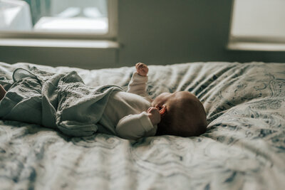 man holding baby in nursery