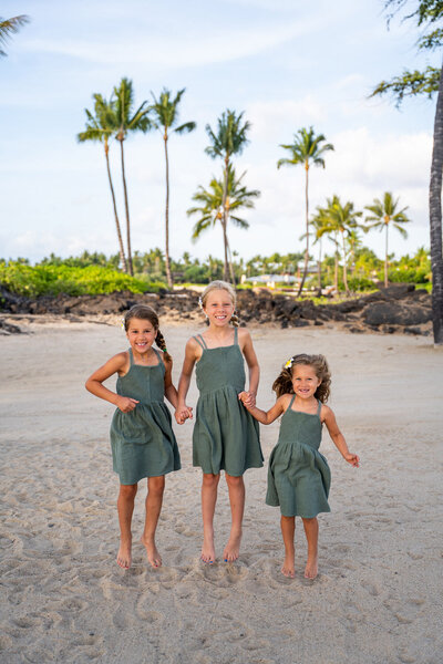 beach family portrait with palm trees by a Big Island family photographer