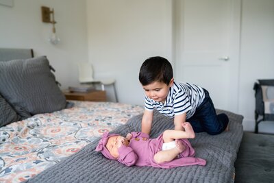 Brother with newborn baby girl for Seattle newborn photo session