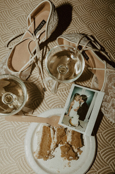 high flash flat lay of wedding reception with champagne and polaroids
