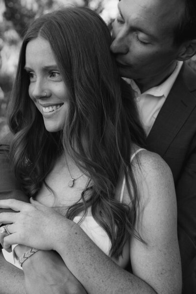 engaged couple standing on the red rocks in st. george, utah taken by jackson hole wedding photographer adrian wayment photo