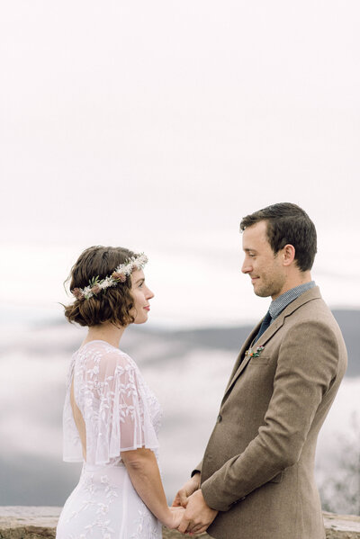Black and white portrait of bride and groom in the mountains, styled in a documentary editorial aesthetic.
