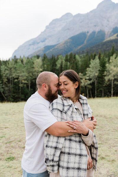 Couple hugging and cuddling in the Rocky Mountains, Canada