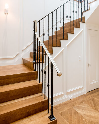 Custom wood staircase with black metal railings in a Boston luxury home interior